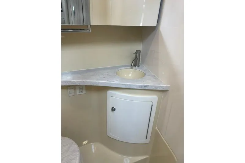 Slide: The Image of 2020 Regal 28 Express bathroom with modern sink and storage cabinet. - 18