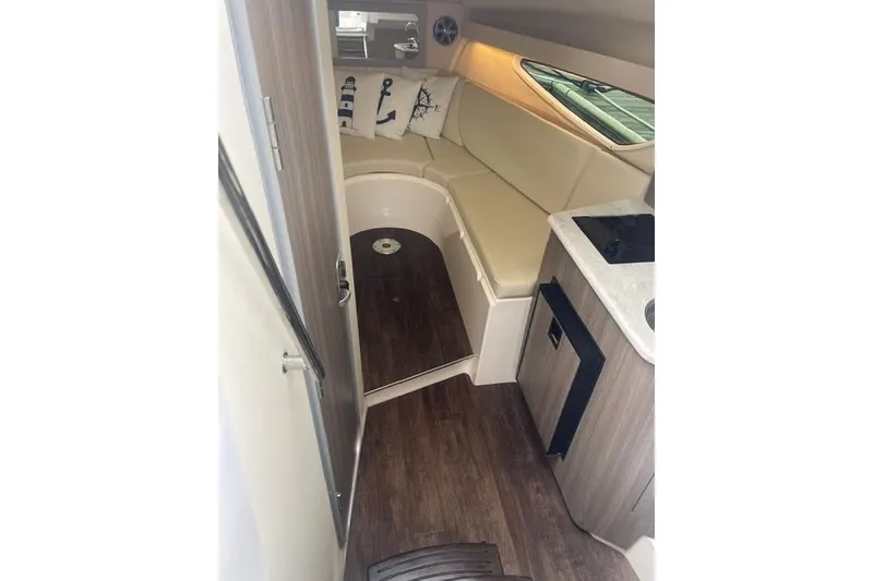 Slide: The Image of Interior of 2020 Regal 28 Express boat with cozy seating and modern amenities. - 20