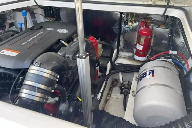 Slide: The Image of Engine compartment of a 2020 Regal 28 Express boat, featuring a Volvo Penta engine. - 24