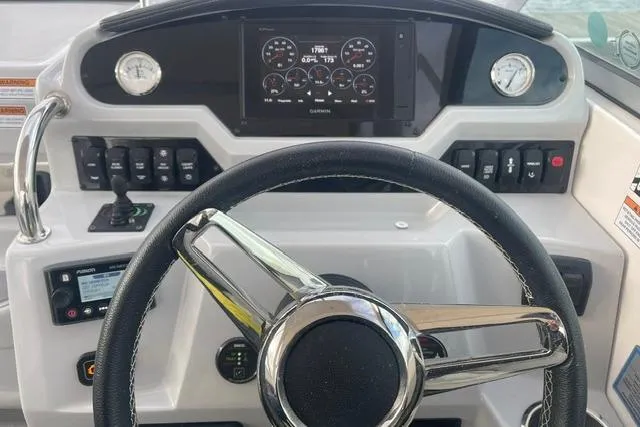 Slide: The Image of Cockpit of 2020 Regal 28 Express boat with steering wheel and control panel. - 8