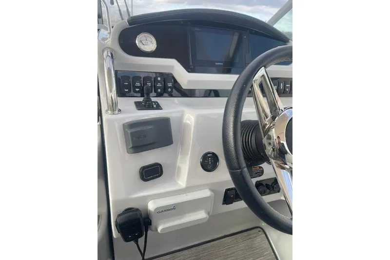 Slide: The Image of Helm of 2020 Regal 28 Express boat with Garmin navigation system and control panel. - 9