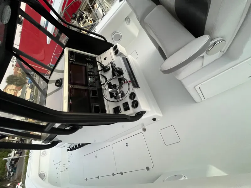 Slide: The Image of The image shows the cockpit of a 2017 Freeman 37VH boat with a modern helm and seating. - 9