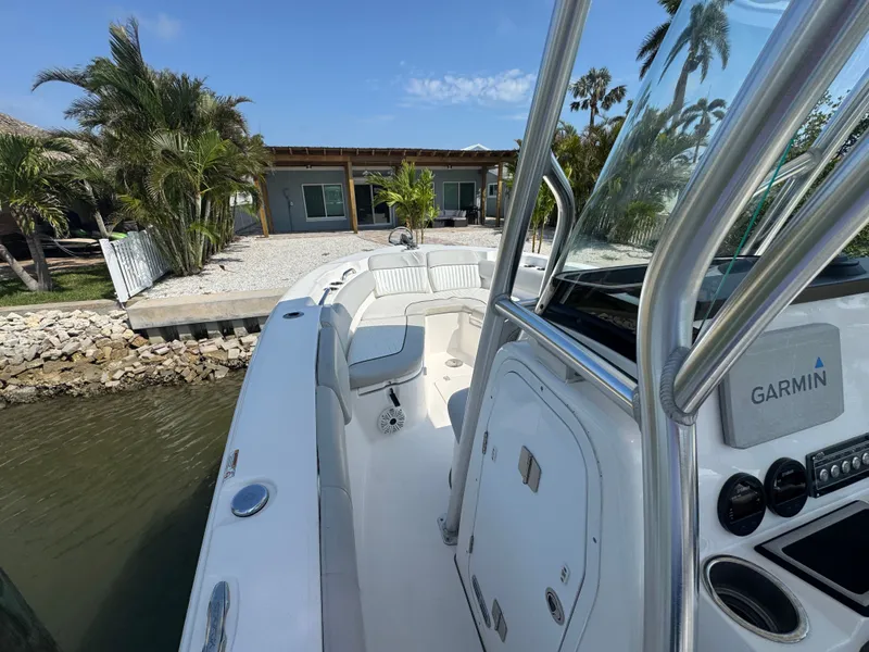 Slide: The Image of 2020 Sea Fox 248 Commander boat by the water with palm trees in background. - 28