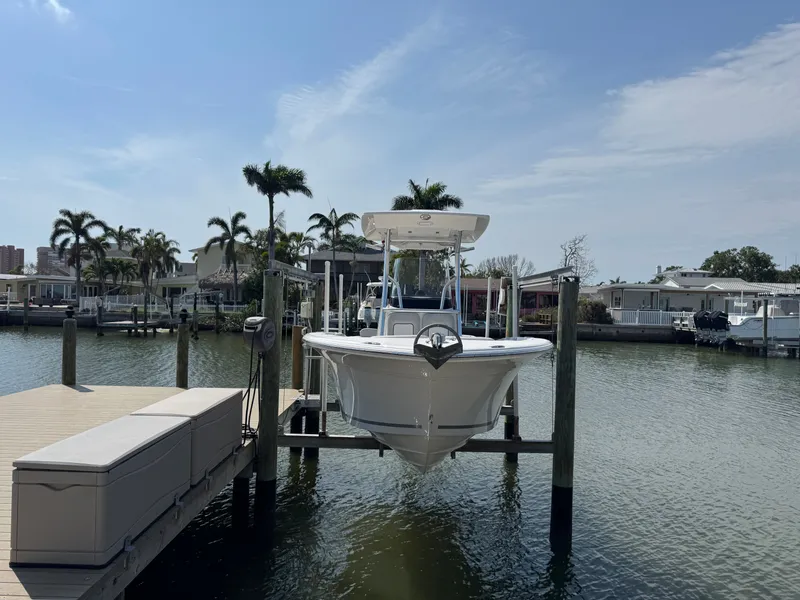 Slide: The Image of 2020 Sea Fox 248 Commander on a boat lift by the water. - 6
