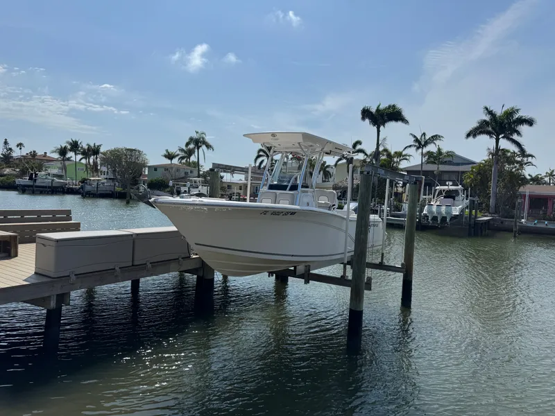 Slide: The Image of 2020 Sea Fox 248 Commander boat docked with palm trees in the background. - 7