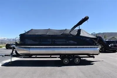 The Image of 2026 Lowe SF 212 Sport Fish pontoon boat on trailer, covered and ready for transport. - 0