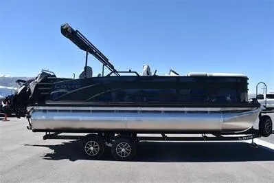 Slide: The Image of 2026 Lowe SF 212 Sport Fish pontoon boat on trailer, side view under clear blue sky. - 10