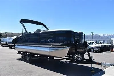 Slide: The Image of 2026 Lowe SF 212 Sport Fish pontoon boat on trailer, parked outdoors. - 11