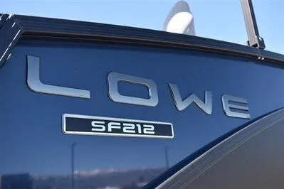 Slide: The Image of 2026 Lowe SF 212 Sport Fish boat logo on sleek blue surface. - 12