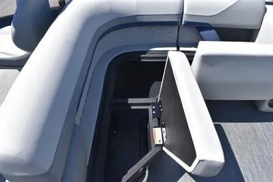 Slide: The Image of 2026 Lowe SF 212 Sport Fish boat interior with open storage compartment and cushioned seating. - 24