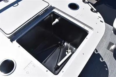 Slide: The Image of 2026 Lowe SF 212 Sport Fish boat livewell with open lid and cup holders. - 29