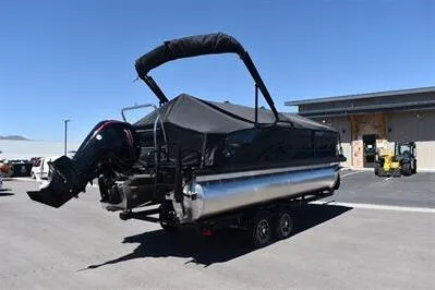 Slide: The Image of 2026 Lowe SF 212 Sport Fish pontoon boat with cover, parked outdoors. - 3