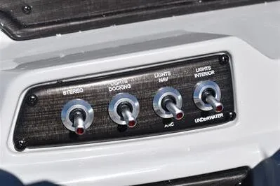 Slide: The Image of Control panel of 2026 Lowe SF 212 Sport Fish boat with switches for stereo and lights. - 33