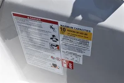 Slide: The Image of Safety and capacity labels on 2026 Lowe SF 212 Sport Fish boat. - 37