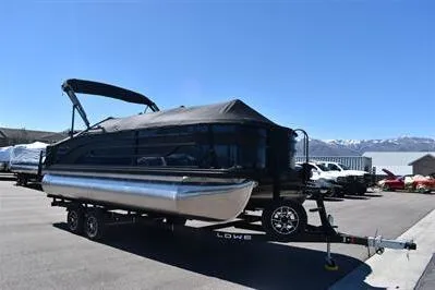 Slide: The Image of 2026 Lowe SF 212 Sport Fish pontoon boat on trailer in parking lot. - 5