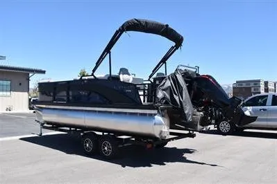 Slide: The Image of 2026 Lowe SF 212 Sport Fish pontoon boat on trailer in parking lot. - 8