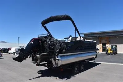 Slide: The Image of 2026 Lowe SF 212 Sport Fish pontoon boat on trailer, parked outdoors. - 9