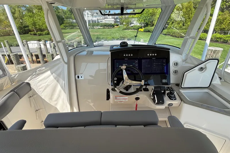 Slide: The Image of 2024 Boston Whaler 350 Realm helm with modern controls and navigation screens. - 14
