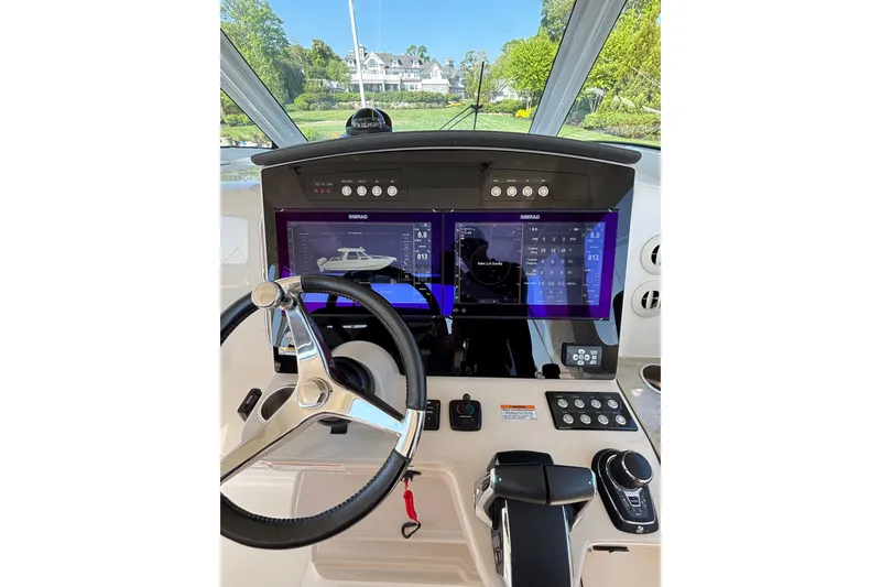 Slide: The Image of Helm of 2024 Boston Whaler 350 Realm with advanced navigation displays and controls. - 15
