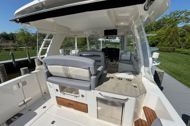 Slide: The Image of 2024 Boston Whaler 350 Realm boat interior with seating and control panel. - 23