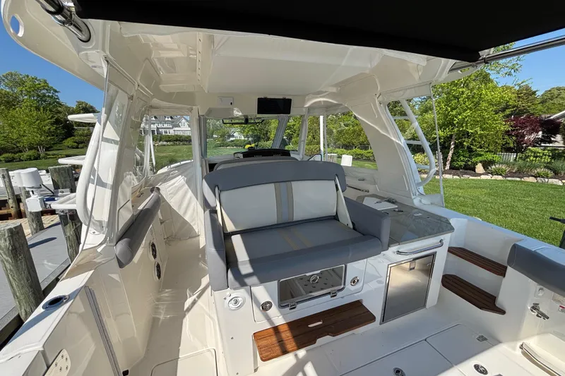 Slide: The Image of 2024 Boston Whaler 350 Realm boat interior with seating and modern amenities. - 27