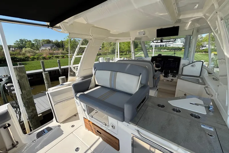 Slide: The Image of Interior of 2024 Boston Whaler 350 Realm boat, featuring modern seating and control panel. - 28