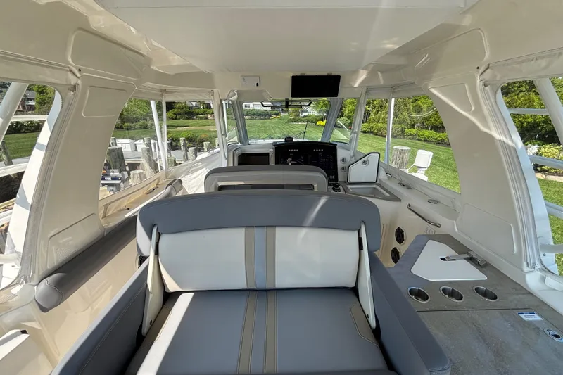 Slide: The Image of Interior view of 2024 Boston Whaler 350 Realm boat, featuring seating and control panel. - 31