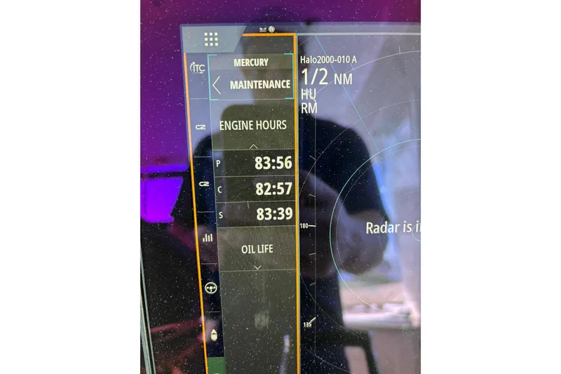 Slide: The Image of Display screen of a 2024 Boston Whaler 350 Realm showing engine hours and radar status. - 32