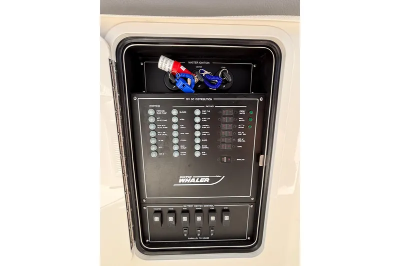 Slide: The Image of Control panel of 2024 Boston Whaler 350 Realm boat, featuring switches and ignition keys. - 37