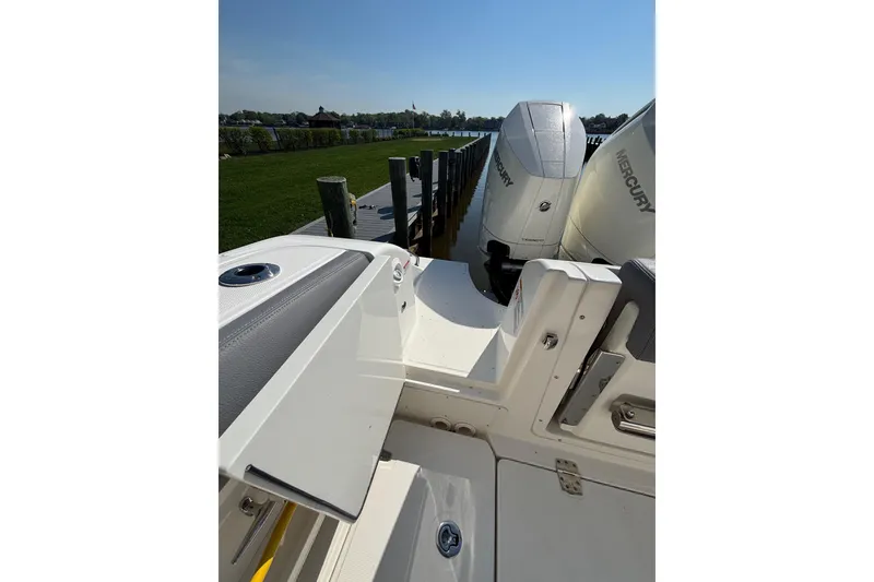 Slide: The Image of 2024 Boston Whaler 350 Realm with Mercury engines docked by the water. - 41