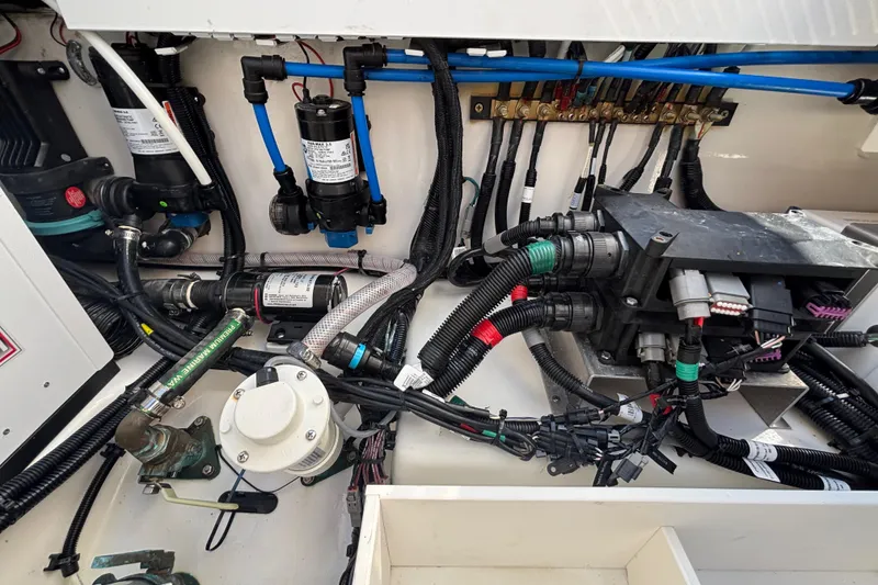 Slide: The Image of 2024 Boston Whaler 350 Realm engine compartment with wiring and components. - 45