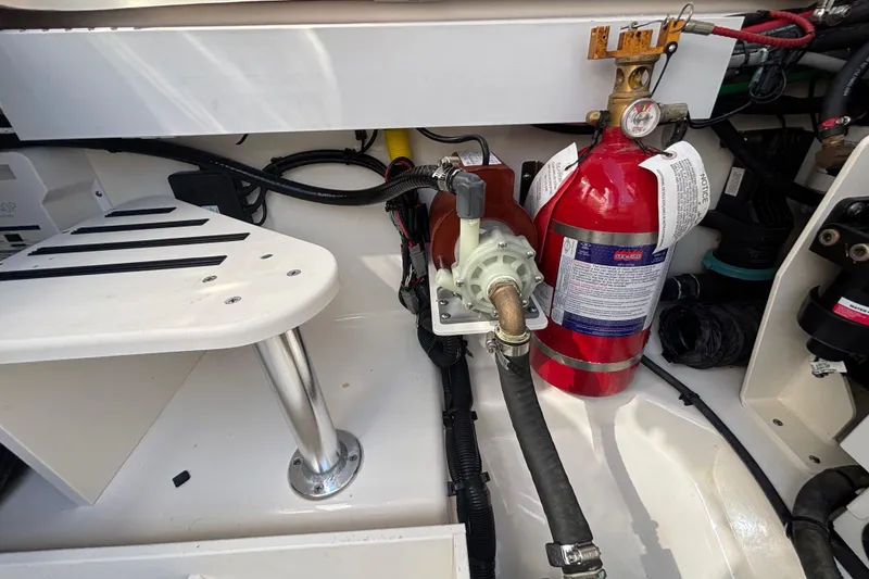 Slide: The Image of Engine compartment of 2024 Boston Whaler 350 Realm with fire extinguisher and pump system. - 46