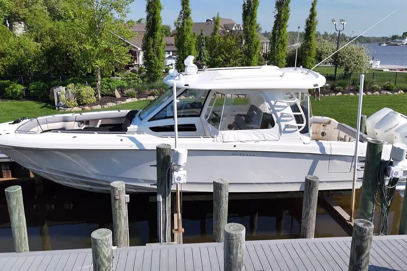 Slide: The Image of 2024 Boston Whaler 350 Realm docked, showcasing sleek design and modern features. - 47