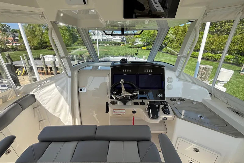 Slide: The Image of 2024 Boston Whaler 350 Realm cockpit with modern controls and panoramic windows. - 6