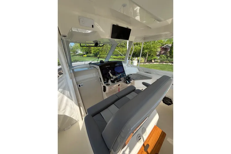 Slide: The Image of 2024 Boston Whaler 350 Realm cockpit with modern navigation equipment and comfortable seating. - 7