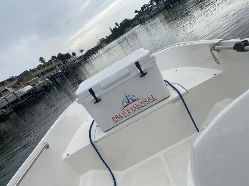 Slide: The Image of Boston Whaler 150 Super Sport 2018 on calm water with cooler. - 16