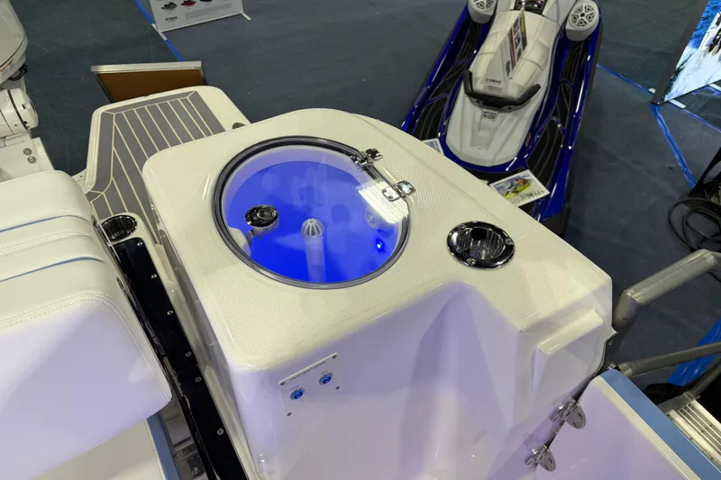 Slide: The Image of 2026 Robalo R317 Dual Console boat with illuminated livewell and seating area. - 10