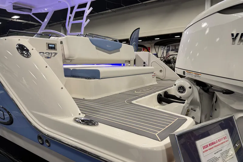 Slide: The Image of 2026 Robalo R317 Dual Console boat interior with Yamaha engine, showcased indoors. - 15
