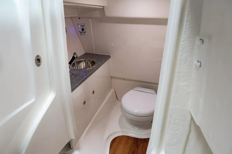 Slide: The Image of Manufacturer Provided Image: 2025 Robalo R317 Dual Console boat bathroom with sink and toilet. - 28