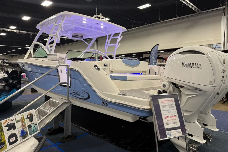Slide: The Image of 2026 Robalo R317 Dual Console boat displayed indoors with Yamaha engine. - 3