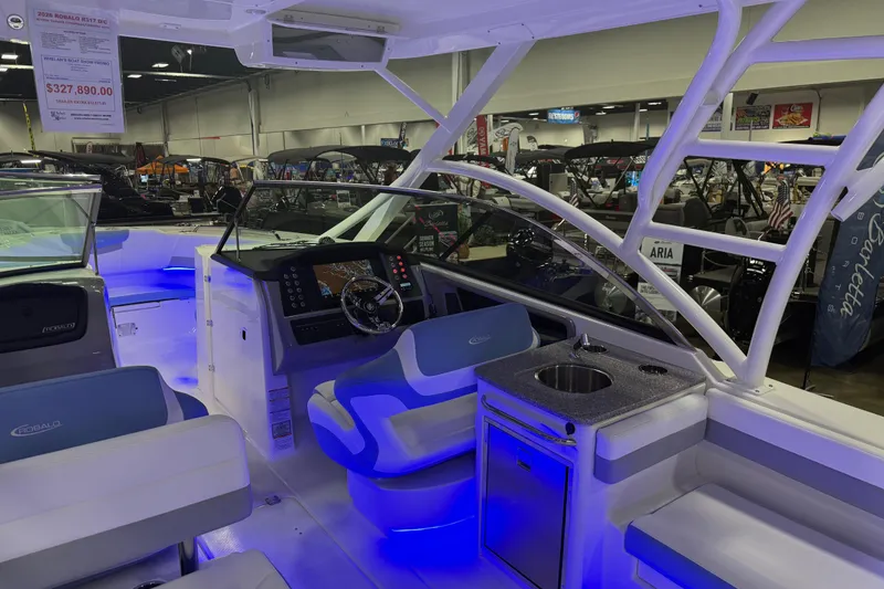 Slide: The Image of 2026 Robalo R317 Dual Console boat interior with modern dashboard and seating. - 4