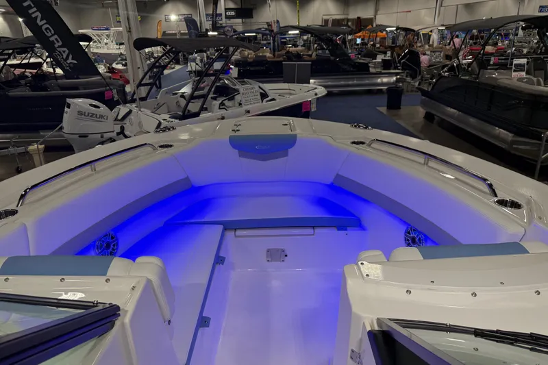 Slide: The Image of 2026 Robalo R317 Dual Console boat interior with blue LED lighting at a boat show. - 5