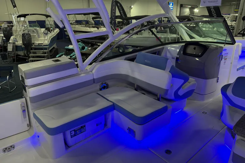 Slide: The Image of 2026 Robalo R317 Dual Console boat interior with blue LED lighting and seating arrangement. - 7