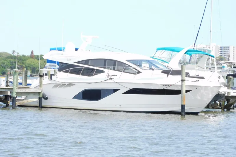 Slide: The Image of 2019 Sea Ray L550 yacht docked at marina, featuring sleek design and modern amenities. - 1