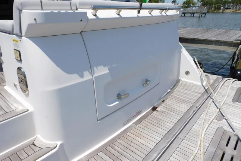 Slide: The Image of 2019 Sea Ray L550 yacht stern view with teak decking and storage compartment. - 18