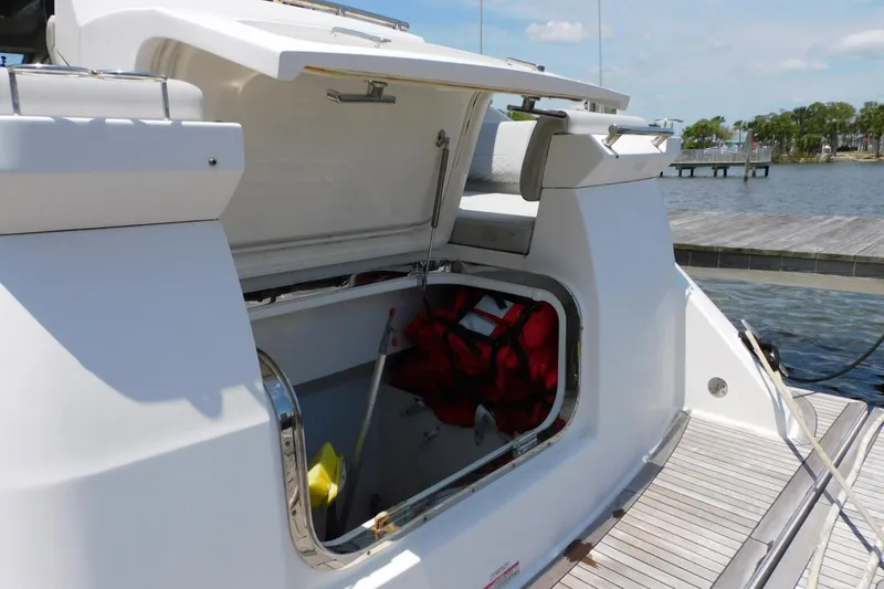 Slide: The Image of Open storage compartment on 2019 Sea Ray L550 yacht docked by the water. - 19