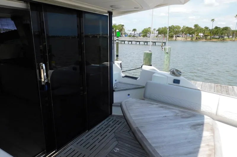 Slide: The Image of 2019 Sea Ray L550 yacht deck with seating and water view. - 21
