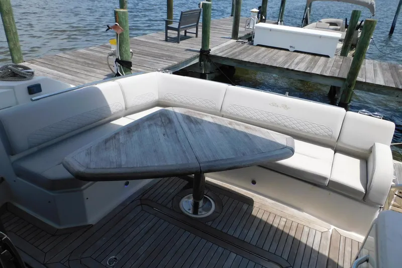 Slide: The Image of 2019 Sea Ray L550 yacht with elegant seating and wooden table on deck. - 23