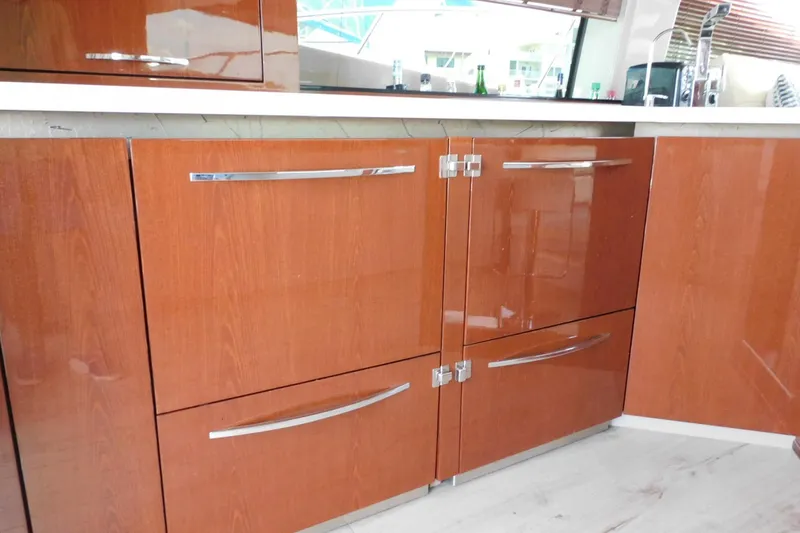 Slide: The Image of Luxurious wooden cabinetry in the 2019 Sea Ray L550 yacht kitchen. - 27