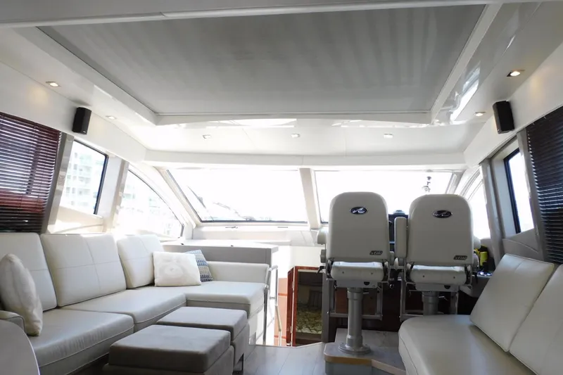 Slide: The Image of Luxurious interior of a 2019 Sea Ray L550 yacht with plush seating and helm chairs. - 28